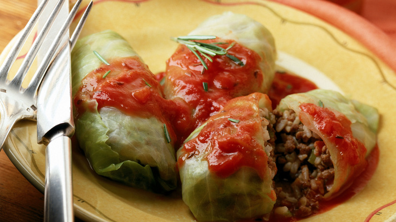 Close up of cabbage rolls covered in sauce