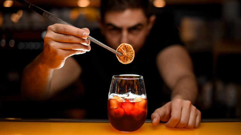 Person making a cocktail