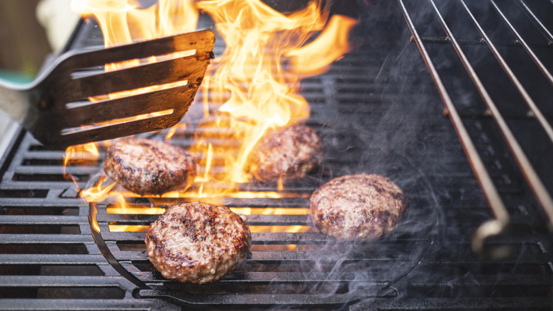 Burger patties cooking on grill