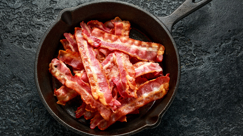 Pile of bacon in cast iron pan