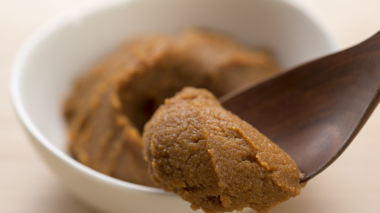 Spoon with miso in white bowl