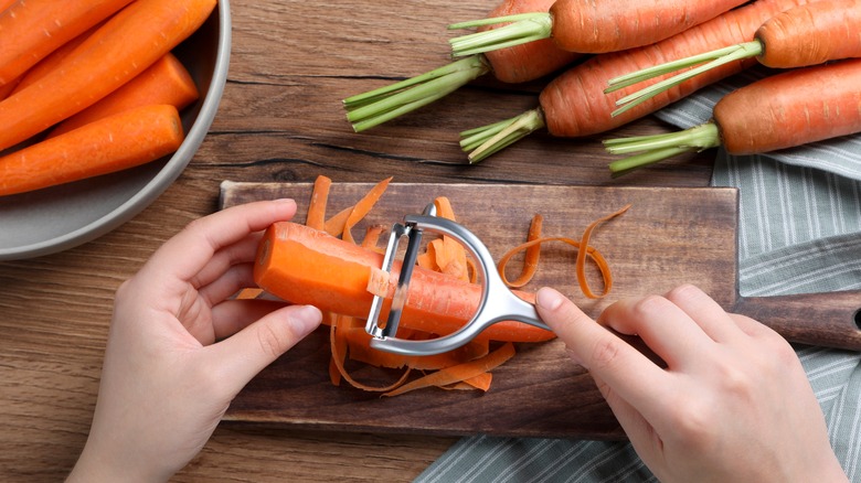 Woman peeling carrots