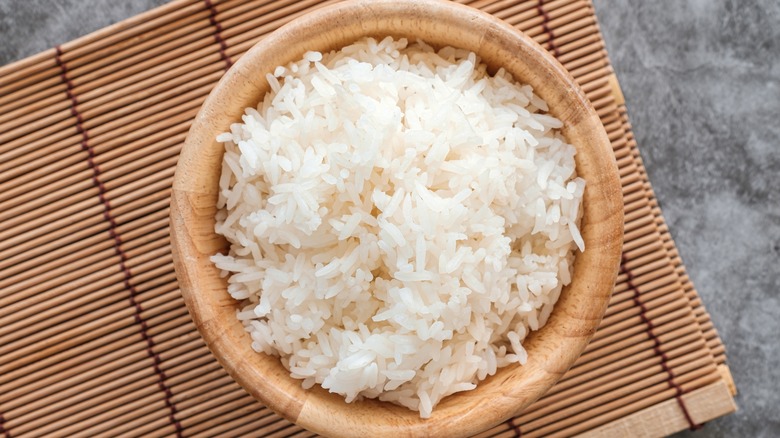 bowl of rice on bamboo mat