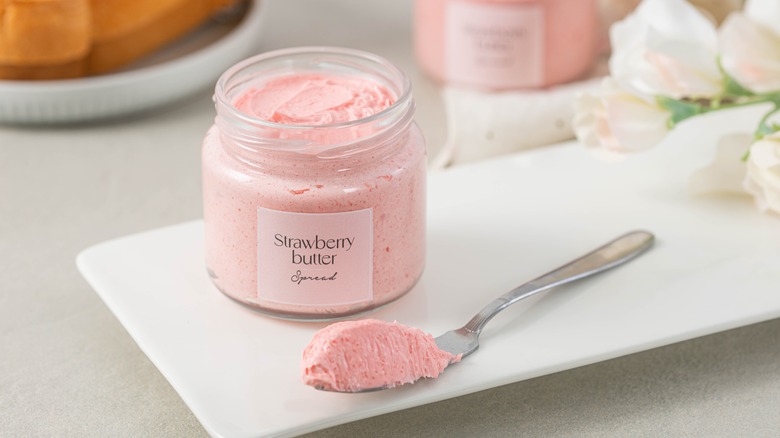 jar of strawberry butter with knife