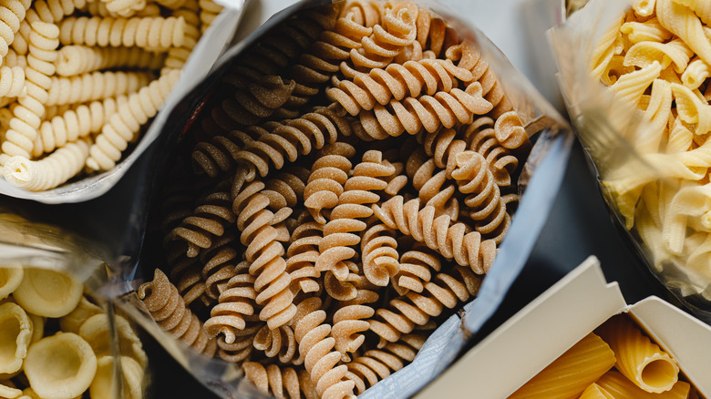 Overhead view of dry pasta in open bags