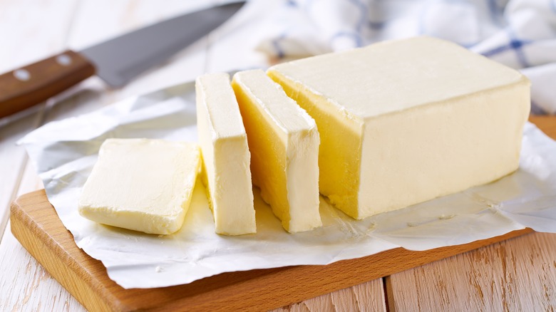 Butter stick sliced on a cutting board