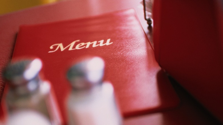 Red menu book on table