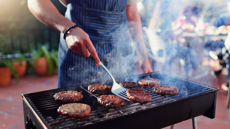 Person grilling burgers