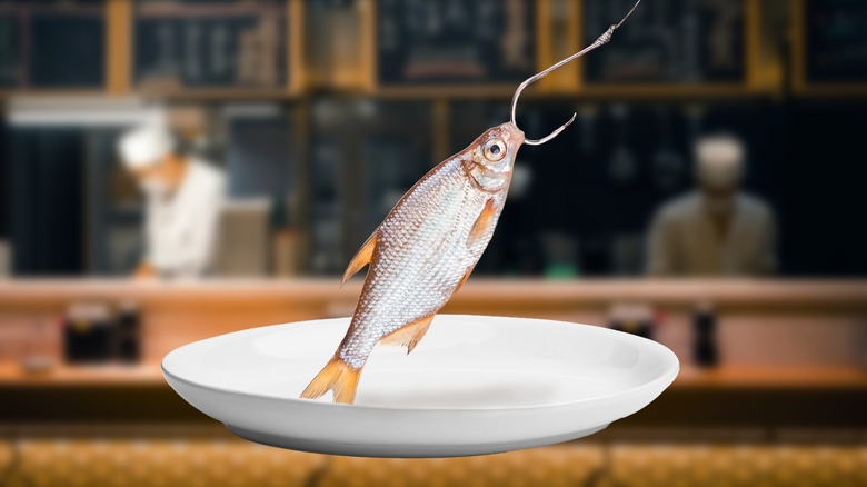 Fish hooked over a white plate