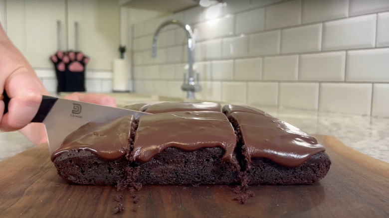 woman slicing chocolate Great Depression cake into squares