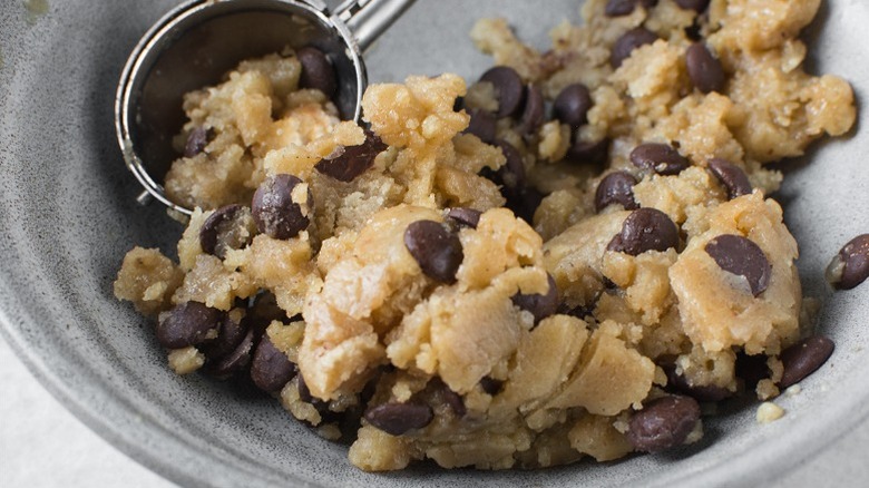 Scooping chocolate chip cookie dough