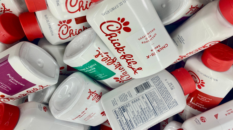 pile of Chick-fil-A sauce bottles