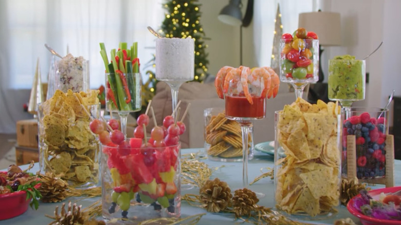 Goblets, lanterns, and trays full of fruits and crackers