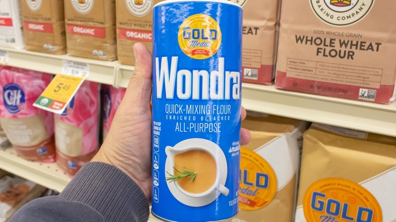 Person holding canister of Wondra