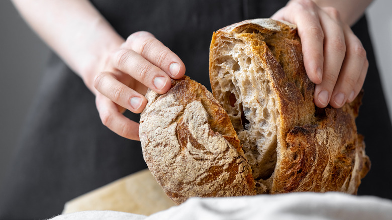 cutting open sourdough loaf