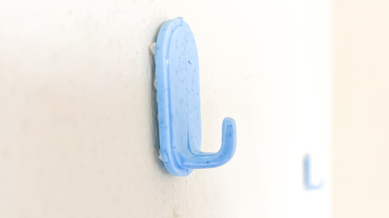 Small, single kitchen hooks with adhesive backing