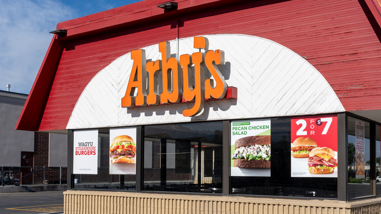 Aby's storefront sign with ads in windows