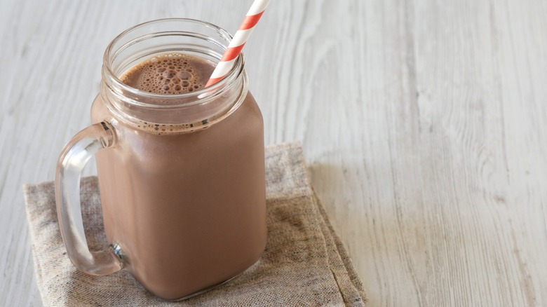 Glass of chocolate milk with straw
