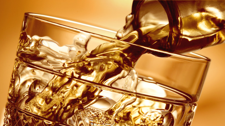 whiskey being poured in a glass