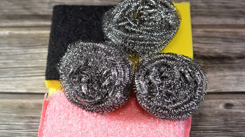 Steel wool on top of pile of kitchen sponges