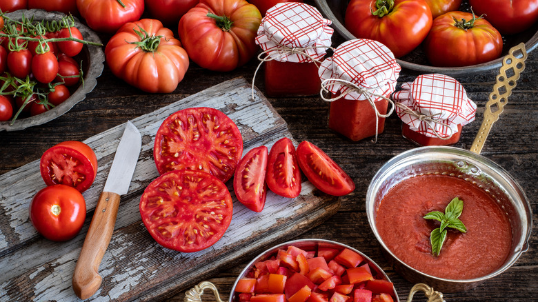 Sliced tomatoes next to jarred sauce