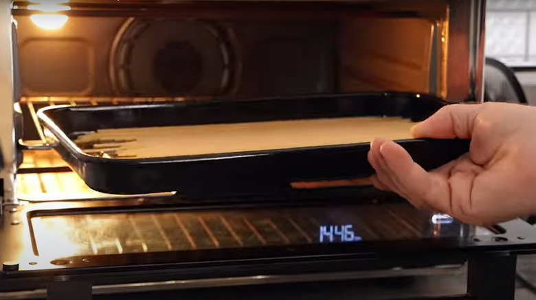 Putting pasta in oven for toasting