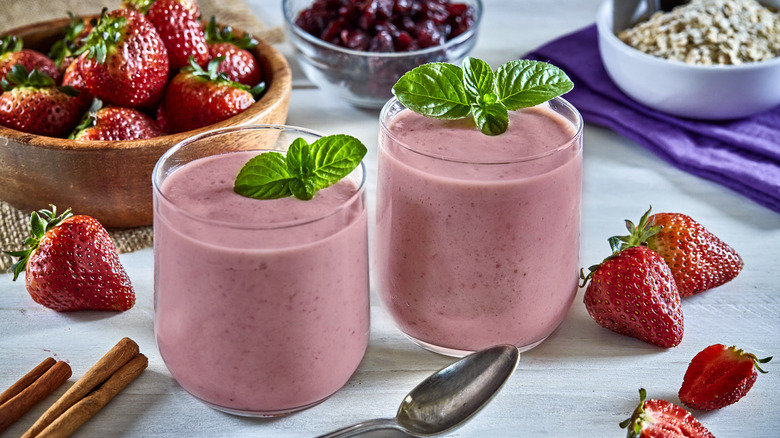 strawberry smoothies surrounded by fruit