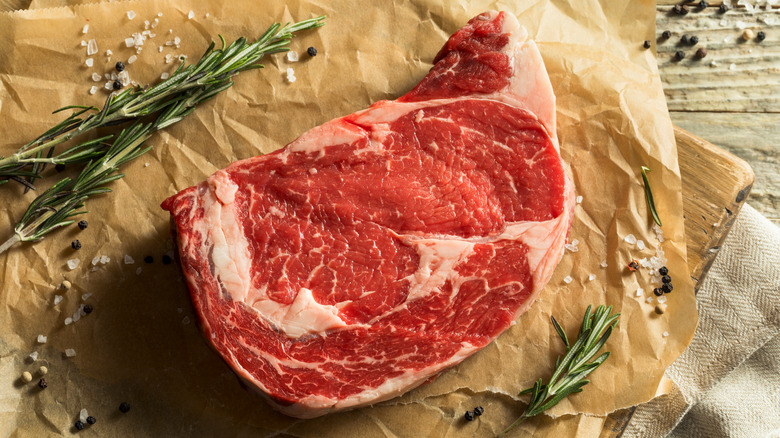 Boneless ribeye steak on parchment paper