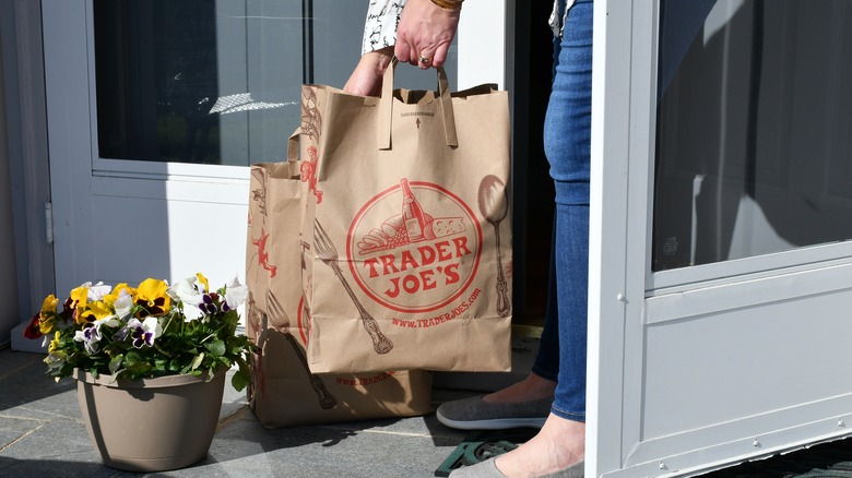 woman picking up delivery on porch