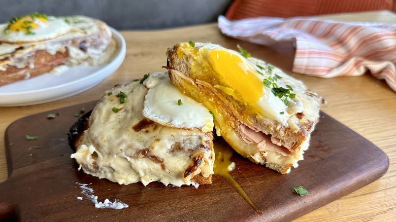 croque madame sandwich on cutting board