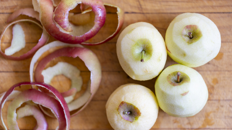 peeled apples next to apple peels