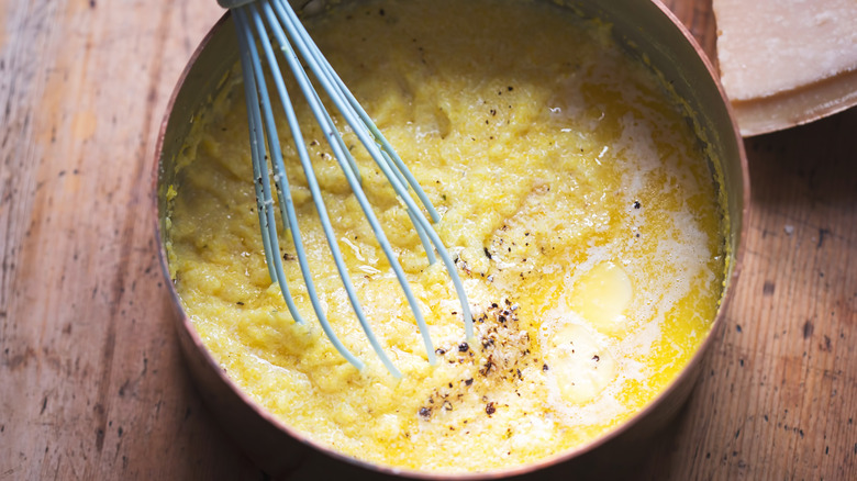 Pot of grits with whisk