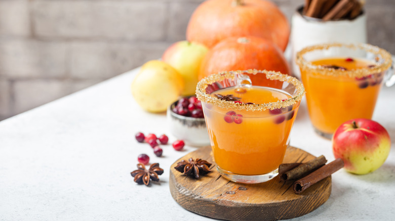 pumpkin cocktail with sugar rim on wood board