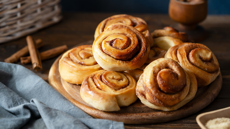 Platter of cinnamon rolls on wooden table