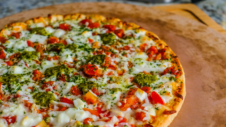 Cooked pizza on a pizza stone