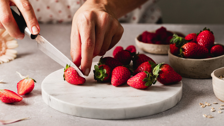 Hand cutting berries