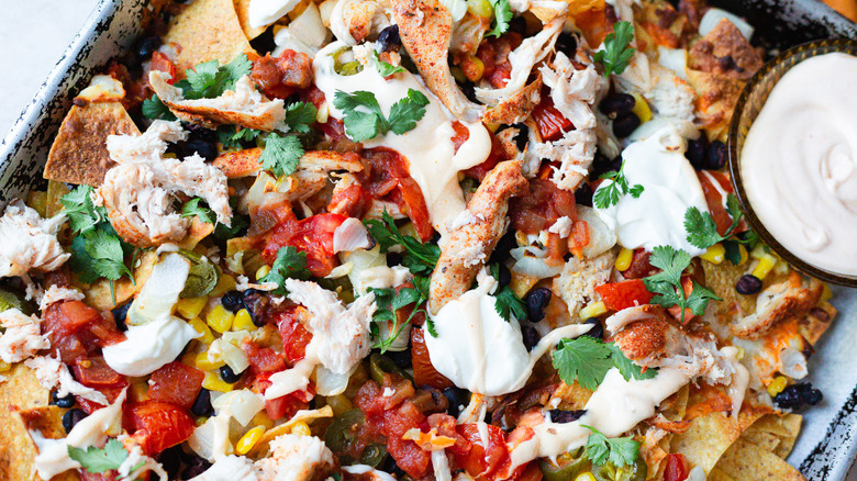 close up on nachos with spicy mayo
