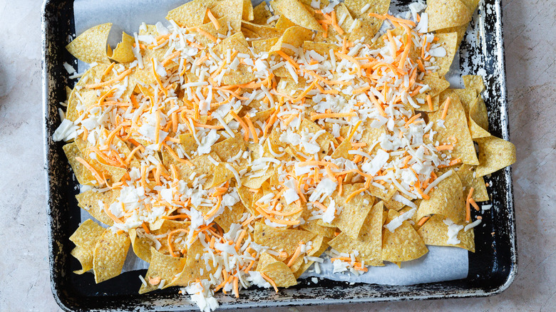 nachos topped with cheeses