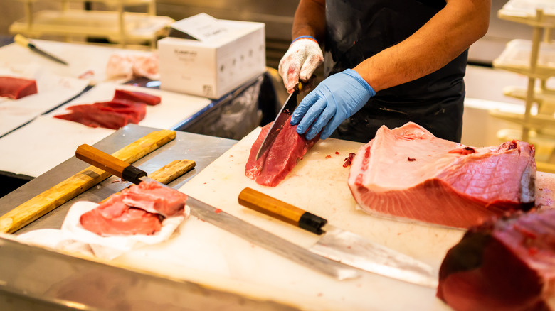 Man cutting tuna