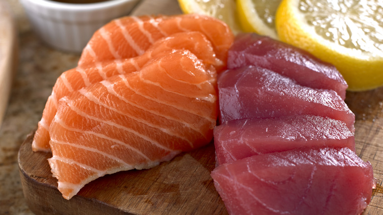 Fresh tuna and salmon sashimi with a slice of lemon