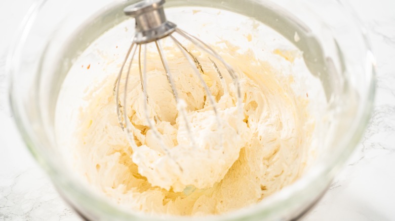 Vanilla frosting with whisk