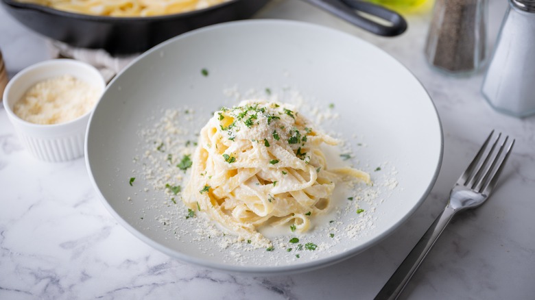 mound of pasta alfredo on plate