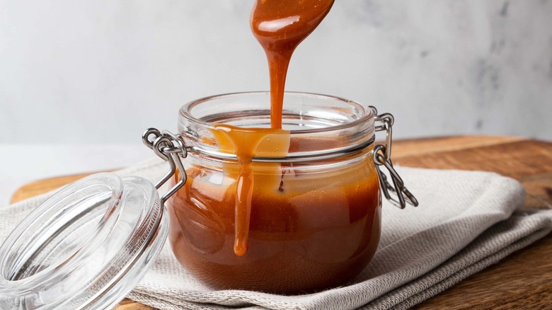 jar of caramel sauce with spoon