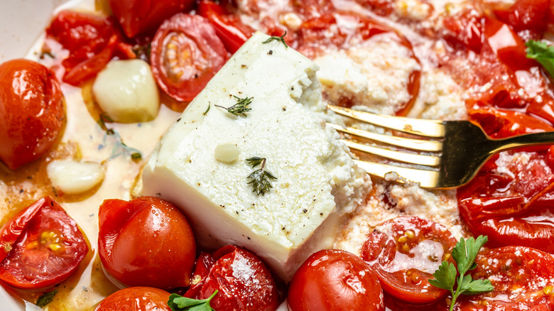 Crushing baked feta and tomatoes 