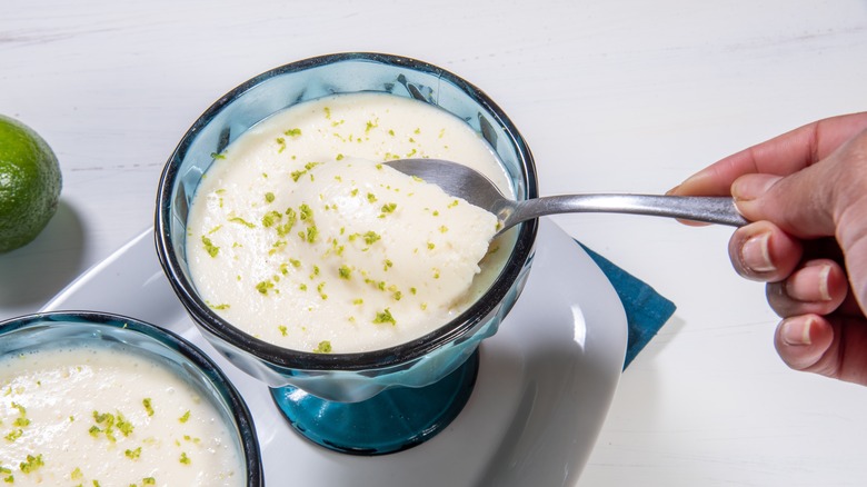 Spoon in blue bowl of margarita mousse