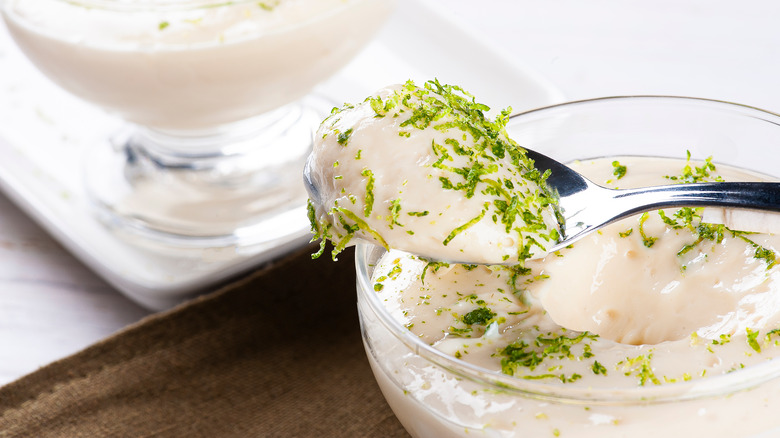 Spoonful of creamy dessert with lime zest