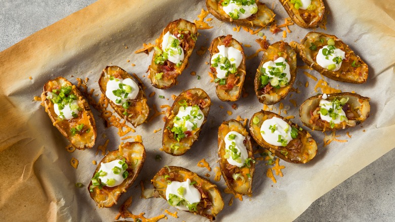 Loaded potato skins on a baking sheet