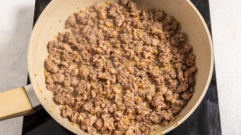 Skillet with ground sausage cooking