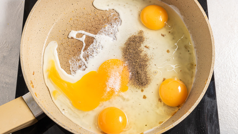 Skillet with eggs, salt, and pepper