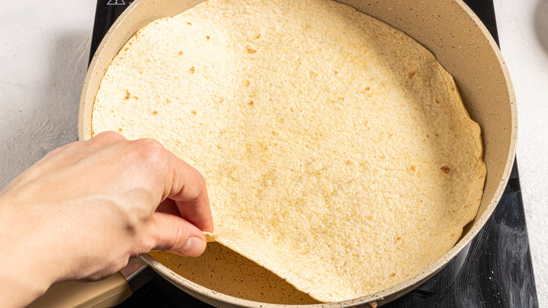 Flipping tortilla on a skillet